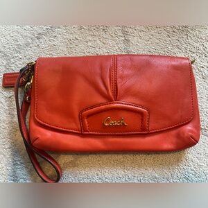 Coach wristlet Like New! Orange color with gold hardware.